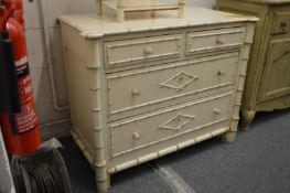 A painted faux bamboo chest of drawers.