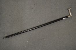 A walking stick, the handle modelled as leg.