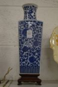 Chinese tapering square form blue and white vase on hardwood stand.