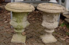 A pair of composite classical urn shaped planters.