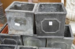 Four square shaped faux lead planters.