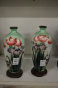 A pair of cloisonne vases on stands (some damage).