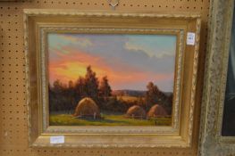 Hayricks at sunset, oil on board.