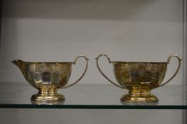 A silver sugar bowl and matching cream jug.