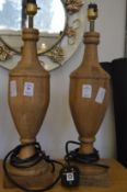 A pair of turned wooden table lamps.