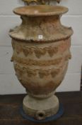 A large salt glazed vase shaped urn with grape and vine decoration.