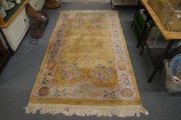 A Chinese gold ground rug 7' 4