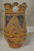 A small decorated terracotta urn.