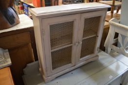 A small painted two door cabinet.
