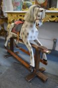 A good painted rocking horse on pine stand.