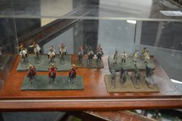 Perspex case containing five sets of miniature military figures.
