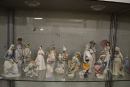 A good collection of Lladro and similar figures, some signed.