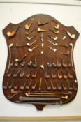 A good large collection of smoking pipes mounted on an oak shield shaped plaque.