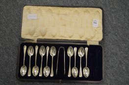A part cased set of silver coffee spoons with sugar tongs.