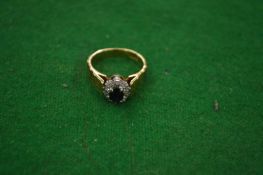 An 18 carat gold, platinum, diamond and sapphire ring.