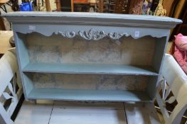 A distress blue painted wall shelf.