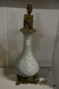 A good Chinese form celadon ground bottle vase/lamp with moulded decoration.