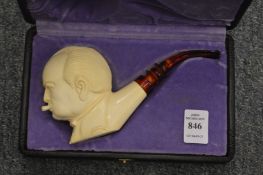 A cased meerschaum pipe in the form of Winston Churchill.