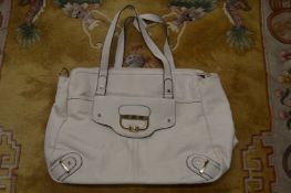 A Ladies cream colour handbag.