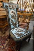 A Victorian ebonised frame and beadwork upholstered prie-dieu.