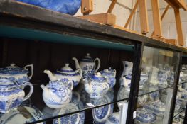 A large quantity of blue and white teapots and jugs.