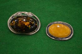 Two silver brooches.