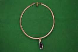 A 9 carat gold necklace with amethyst colour drop pendant.