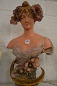An Art Nouveau pottery bust of a young girl.