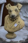 An amusing garden sculpture modelled as the bust of a dog wearing a jacket.