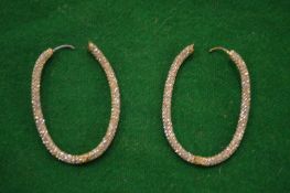 A pair of decorative earrings.
