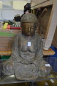 A large model of a seated buddha.