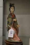 A Japanese cloisonne model of a woman.