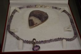 A decorative necklace and pendant set.