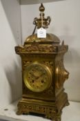 A decorative brass mantel clock.