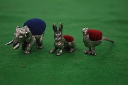 Three novelty pin cushions.