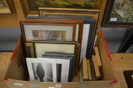 A box of paintings and prints.