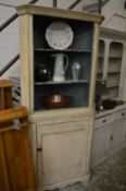 A painted standing corner cupboard.