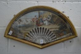A gilt wood display case containing a decorative painted French fan.