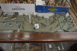 A group of miniature military figures mounted on wooden bases.