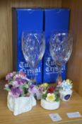 A pair of cut glass wine glasses and decorative china.