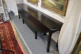 A large ebonised wake table.