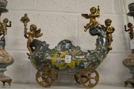 A decorative centrepiece modelled as a carriage with cherubs.