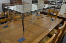 Glass top coffee table with wrought iron base.
