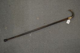 A walking stick, the handle possibly rhino horn.