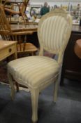 A pair of painted and upholstered single chairs.