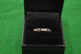 A sapphire and diamond eternity ring.