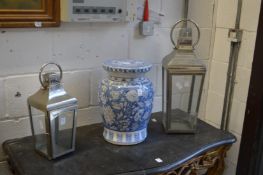 Two metal candle lanterns.