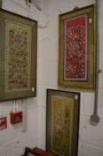 Three Chinese embroidered pictures depicting numerous figures in various scenes.