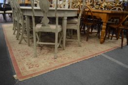 A large cream ground carpet (worn) 12'10