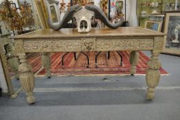 A Victorian carved and painted two drawer writing table with leather inset top.
